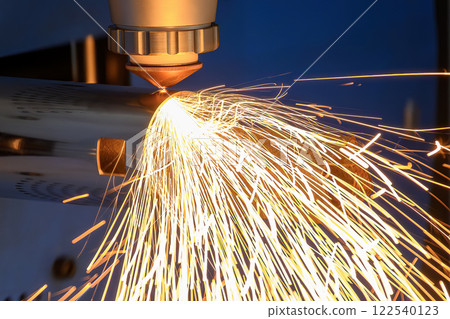 Close up scene the fiber laser cutting machine cut the stainless steel tube and sparkling light. 122540123