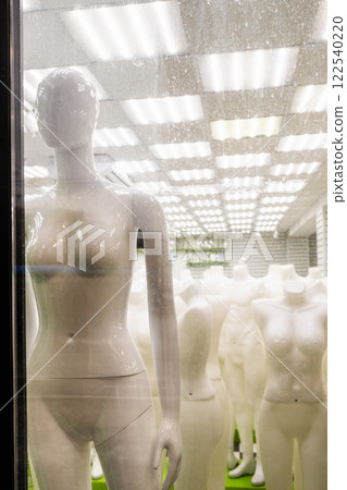 naked female dress mannequin in window display 122540220