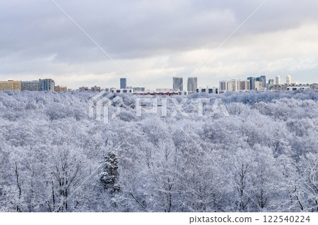 low snow cloud over snowy city park after snowing 122540224