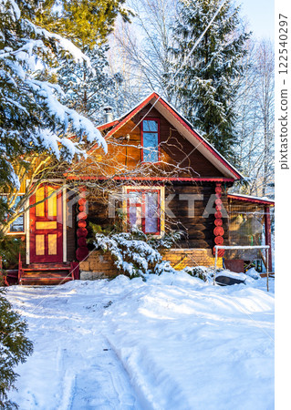snowy path and rural log house in winter snowy path and rural log house in winter 122540297