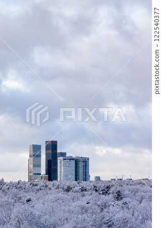 cloudy sky over skyscrapers and park after snowing cloudy sky over skyscrapers and park after snowing 122540377