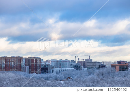 snow clouds over city park in winter evening snow clouds over city park in winter evening 122540492