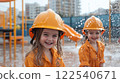 Children in firefighter uniforms playing with water at playground, smiling joyfully 122540671