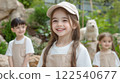 Children in zookeeper outfits smiling outdoors with stuffed animals in natural setting 122540677