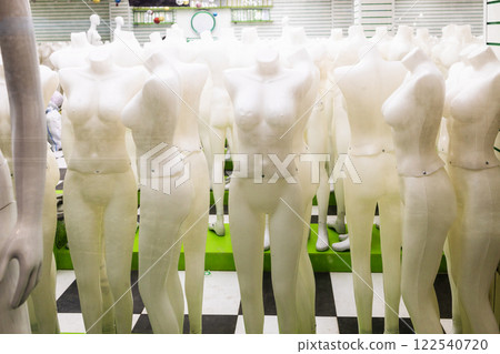 many naked full body dress mannequins in window 122540720