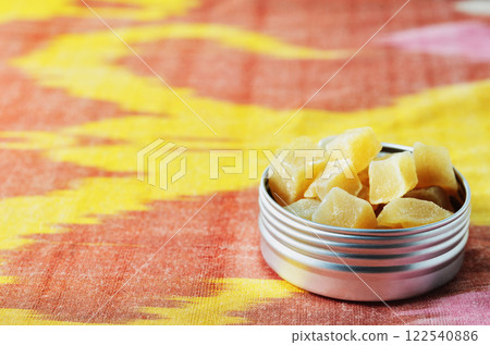Yellow cubes of ginger candies 122540886