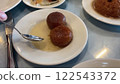 Close-up View of Traditional Turkish Dessert, Kemal Pasha, Served on a White Plate with Syrup 122543372