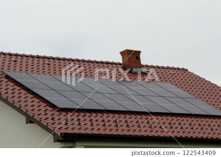 Historic farm house with modern solar panels on roof and wall Illustration 122543409