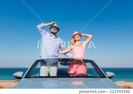 Happy couple in love travel by car by the sea Happy couple in love travel by car by the sea 122543590
