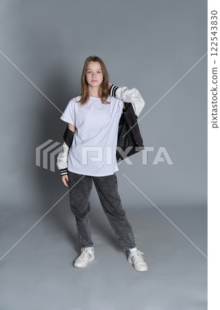 The young girl stands with a confident expression, wearing a casual yet stylish outfit. Her look embodies the balance of youthful innocence and emerging self-awareness common in adolescence. The young girl stands with a confident expression, wearing a casual yet stylish outfit. Her look embodies the balance of youthful innocence and emerging self-awareness common in adolescence. 122543830