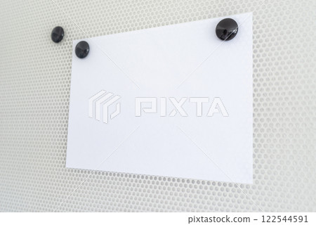 Blank piece of white paper on a magnetic board Blank piece of white paper on a magnetic board 122544591
