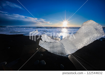 Loose segments of glacier washed out of Jokulsarlon glacial lake onto Diamond Beach on Iceland 122544632