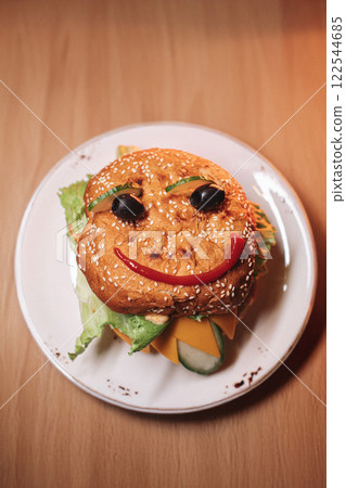 juicy children's burger with a painted face made juicy children's burger with a painted face made 122544685