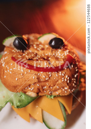 juicy children's burger with a painted face made juicy children's burger with a painted face made 122544686