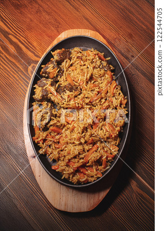 Pilaf in beautiful dishes is on the table in the Pilaf in beautiful dishes is on the table in the 122544705