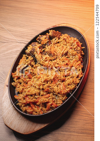 Pilaf in beautiful dishes is on the table in the 122544709