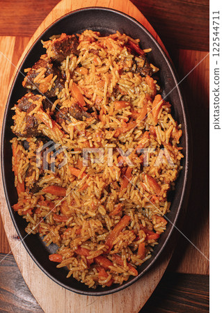 Pilaf in beautiful dishes is on the table in the 122544711