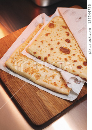 thin pancakes with ham and cheese in an envelope 122544726