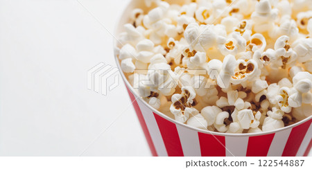 Popcorn bucket. Red and white stripes. Movie night snack. Minimalist food photography style white background. 122544887