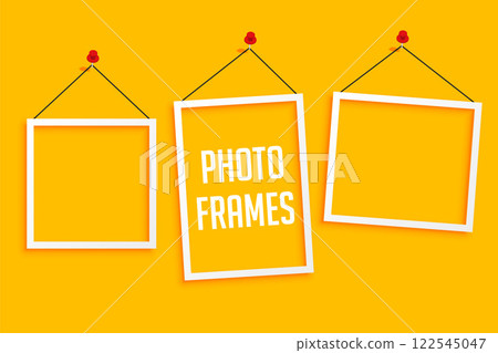 hanging photo frames on yellow background 122545047