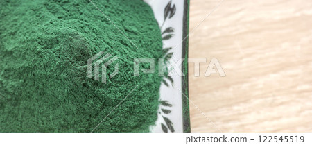 Close up photo of powdered spirulina, selective focus. 122545519