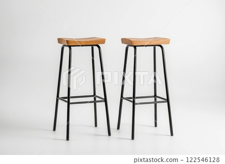 Two sturdy bar stools with a stylish wooden seat and black metal frame, perfect for enhancing dining spaces with a modern touch. 122546128