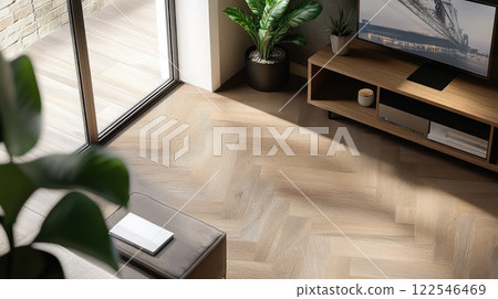 Sunlit living room with herringbone wood floor, modern furniture, and large window. 122546469