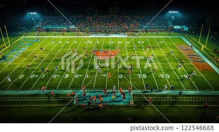 Night football game aerial view, players on field, crowd in stadium. Night football game aerial view, players on field, crowd in stadium. 122546688