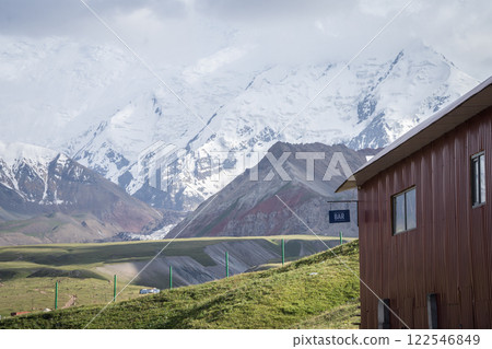 Building with bar sign in expedition camp with huge snowy Pamir Mountains in backdrop, Kyrgyzstan Building with bar sign in expedition camp with huge snowy Pamir Mountains in backdrop, Kyrgyzstan 122546849