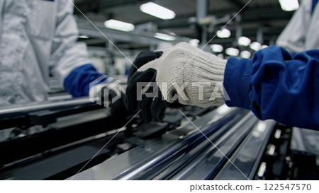 Factory worker assembling components on production line 122547570