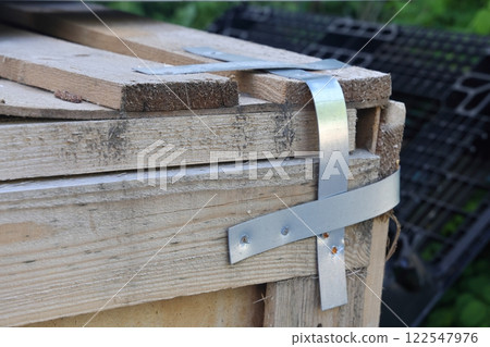 Packing straps close-up, metal strapping tapes, packing, securing loads, clamps, bolts and nuts. 122547976