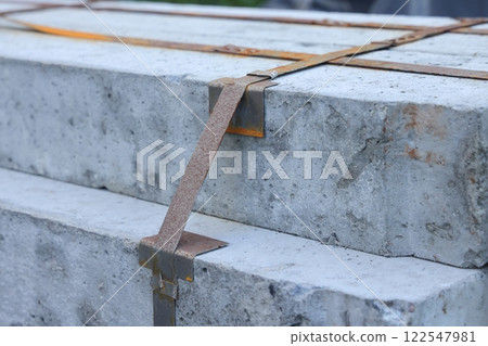 Packing straps close-up, metal strapping tapes, packing, securing loads, clamps, bolts and nuts. Packing straps close-up, metal strapping tapes, packing, securing loads, clamps, bolts and nuts. 122547981