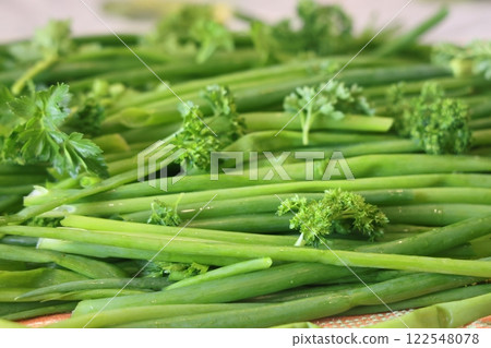 fresh herbs prepared for salads. Parsley and green onions. Proper nutrition, vitamins. 122548078