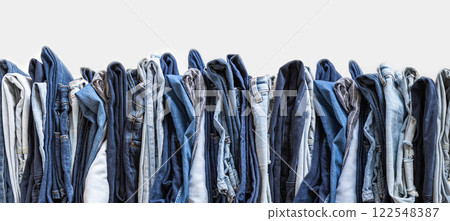 Stack of various shades of blue jeans on white background 122548387