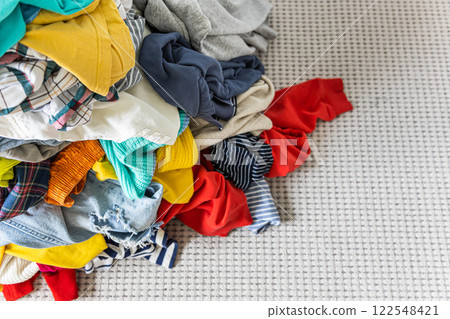 A Bunch of Different Clothes. Recyclable Textile Background. Sorting at Recycling Clothes 122548421