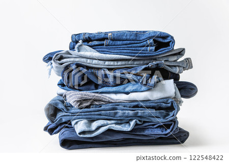 Stack of various shades of blue jeans on white background 122548422