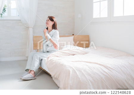 Senior woman stretching on the bed 122548628