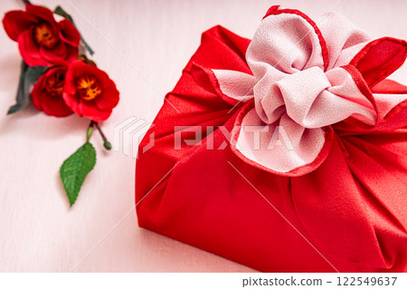 Red furoshiki wrapping and camellia | Pink background 122549637