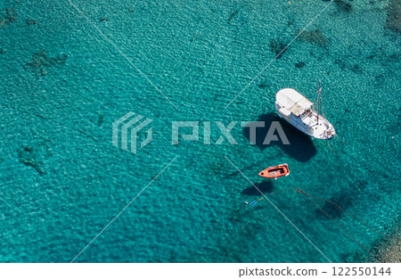 Aerial shoot of boat floating in pristine waters in the Peloponnese. Greece 122550144