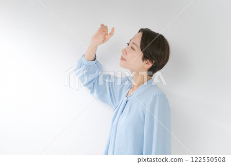 A woman in her 30s blocking the sunlight A woman in her 30s blocking the sunlight 122550508