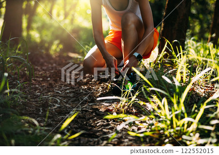 Trail runner running in summer forest trail Trail runner running in summer forest trail 122552015