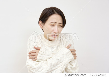 Woman feeling chills on white background 122552305