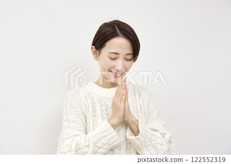 Praying woman on white background 122552319