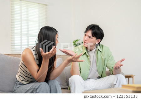 A toxic relationship. An unhappy Asian couple sits in the living room, arguing and having a conflict 122553133