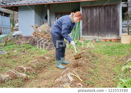 Woman working in the fields, country life, home garden 122553580