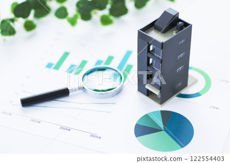 Business graph and corporate building with magnifying glass Business graph and corporate building with magnifying glass 122554403