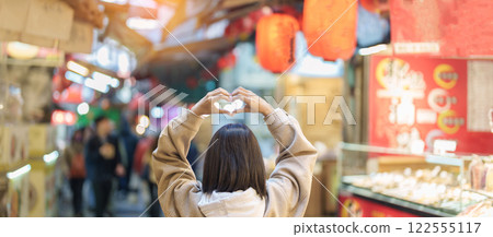 woman traveler visiting in Taiwan, female Tourist with backpack sightseeing and shopping at Jiufen Old Street market. Popular landmark and attractions near Taipei City. Travel and Vacation concept 122555117