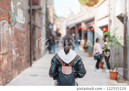 woman traveler visiting in Taiwan, Tourist with backpack sightseeing at Bopiliao Historic Block, landmark and popular attractions in Taipei city. Asia Travel and vacation concept 122555129