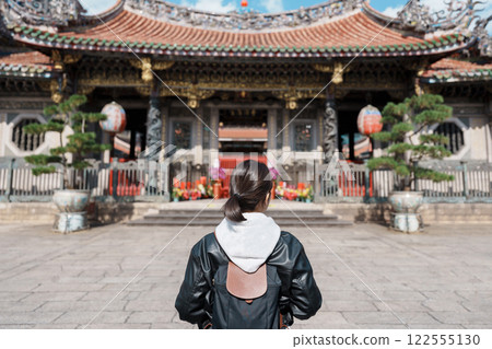 woman traveler visiting in Taiwan, female Tourist sightseeing at Longshan Temple, Chinese folk religious temple in Wanhua District, Taipei City. landmark and popular. Travel and Vacation concept woman traveler visiting in Taiwan, female Tourist sightseeing at Longshan Temple, Chinese folk religious temple in Wanhua District, Taipei City. landmark and popular. Travel and Vacation concept 122555130