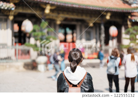 woman traveler visiting in Taiwan, female Tourist sightseeing at Longshan Temple, Chinese folk religious temple in Wanhua District, Taipei City. landmark and popular. Travel and Vacation concept 122555132